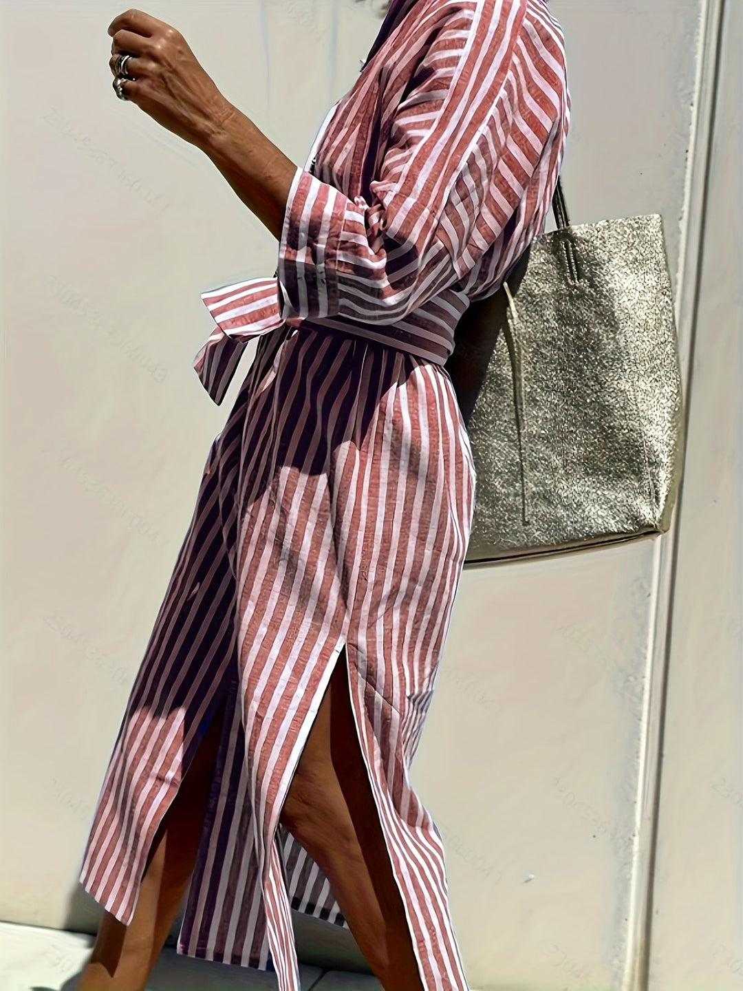 Effortless spring fashion: women's striped midi dress with three-quarter sleeves & belt.