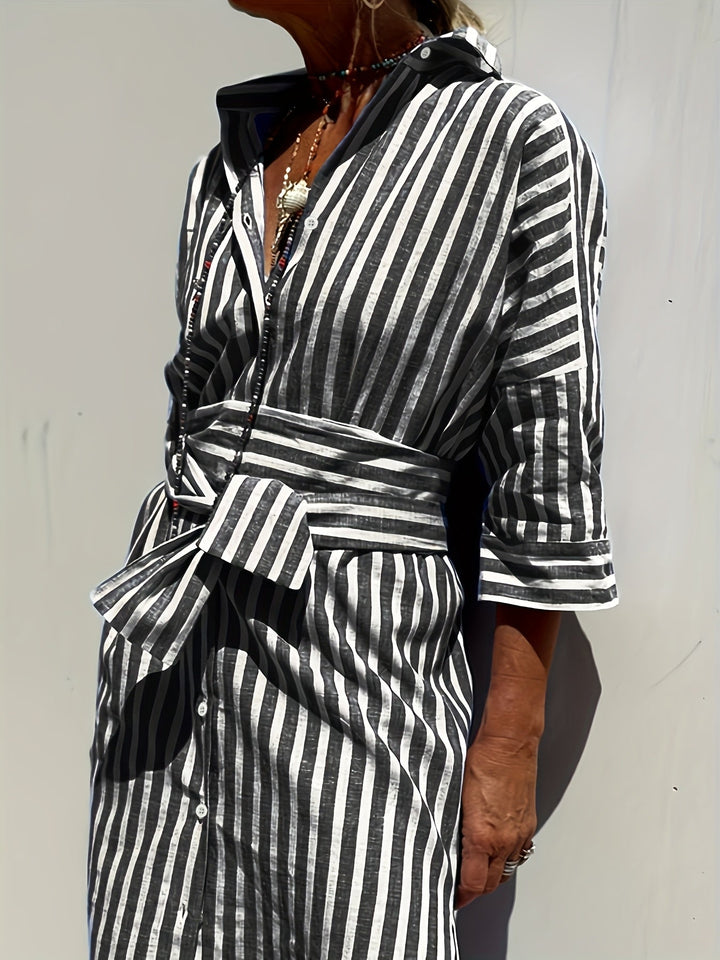 Close-up of a women's striped button-down dress, showing soft fabric & a flattering belted waist.