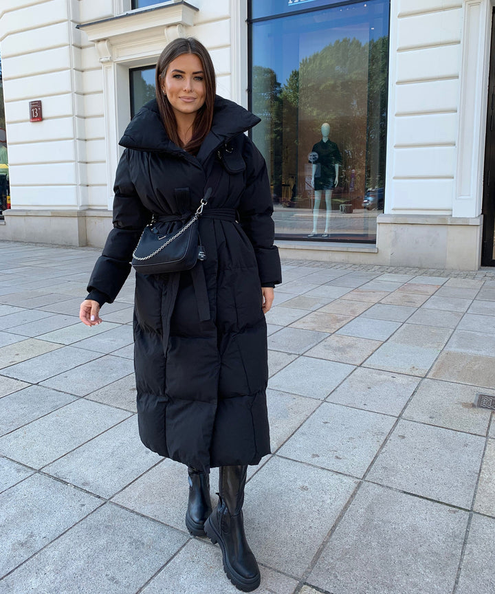 Belted women's elegant long quilted winter coat, designed for ultimate warmth & sophisticated style.