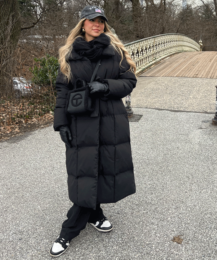 High-collar women's long quilted winter coat, offering sophisticated cold-weather protection & fashion.