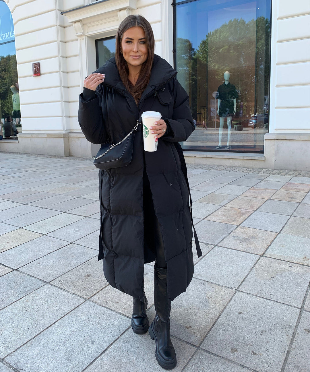 Stylish long quilted winter coat for women, featuring elegant design and warm, quality material.