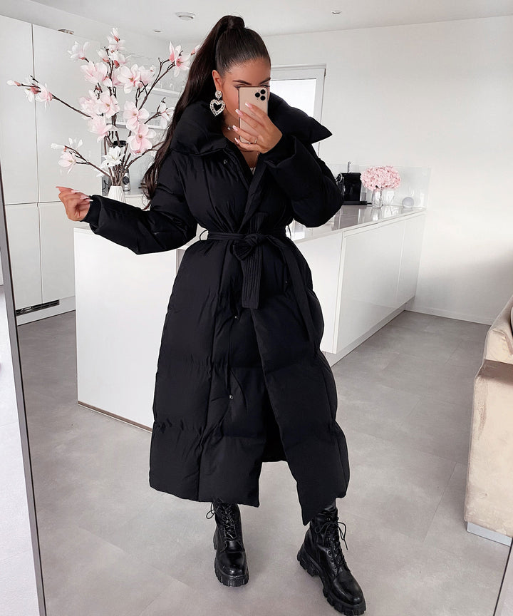 Elegant women's long quilted coat, perfect for staying warm and chic in cold weather.