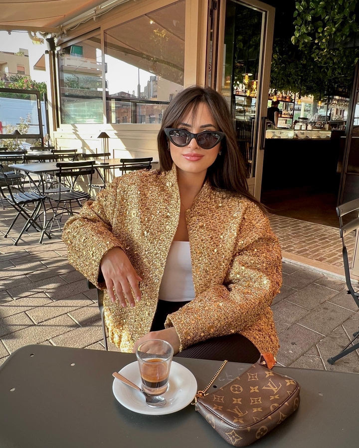 Elegant women's metallic jacket, tailored for a modern statement look, suitable for mid-season evening wear.