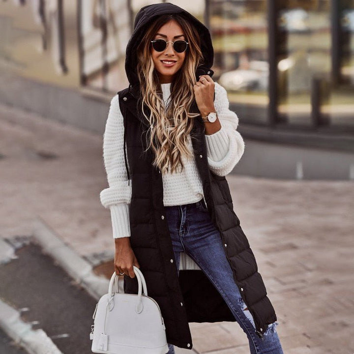 Women's long hooded puffer vest with quilted design. Warm, stylish, and perfect fall/winter outerwear for women.