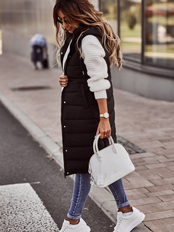 Stylish women's long puffer vest, hooded & quilted. Ideal sleeveless outerwear, perfect layering for casual fall fashion.