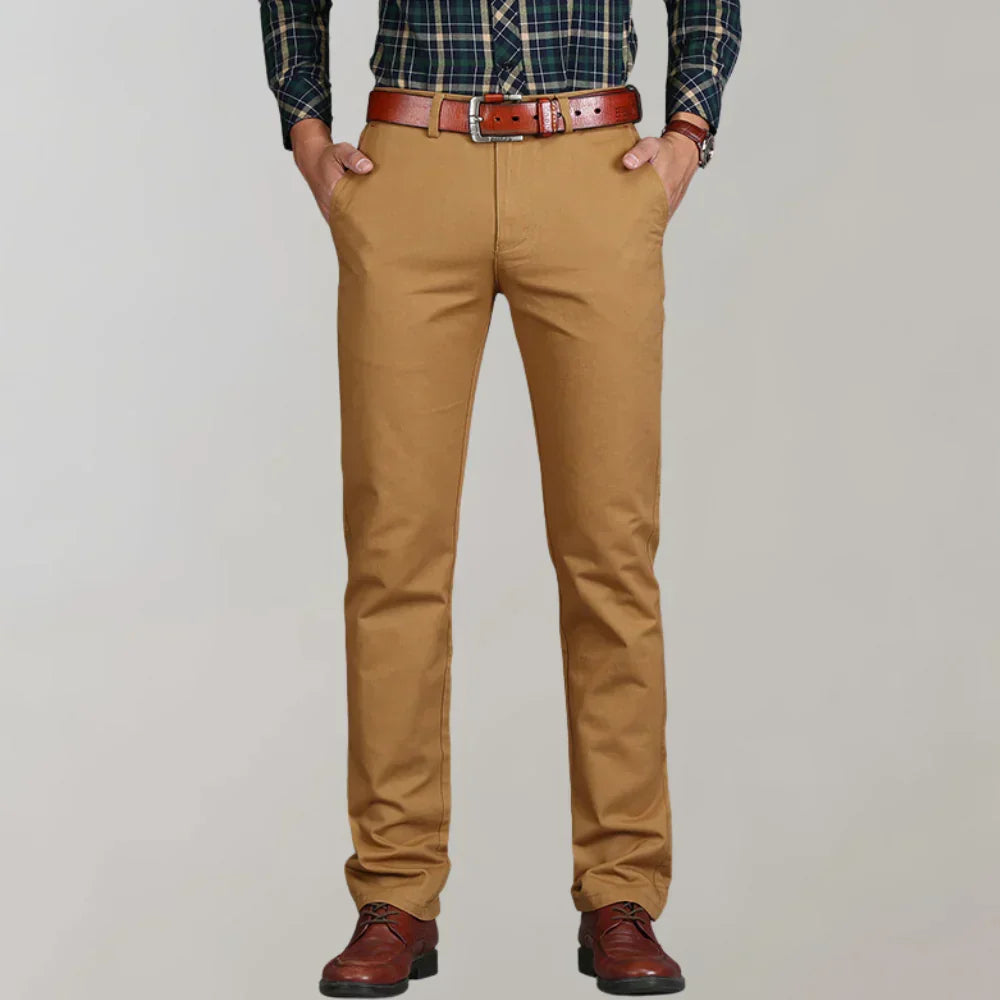 Close-up of men's slim fit chino pants, highlighting fabric texture and sleek modern cut. Perfect for stylish comfort.