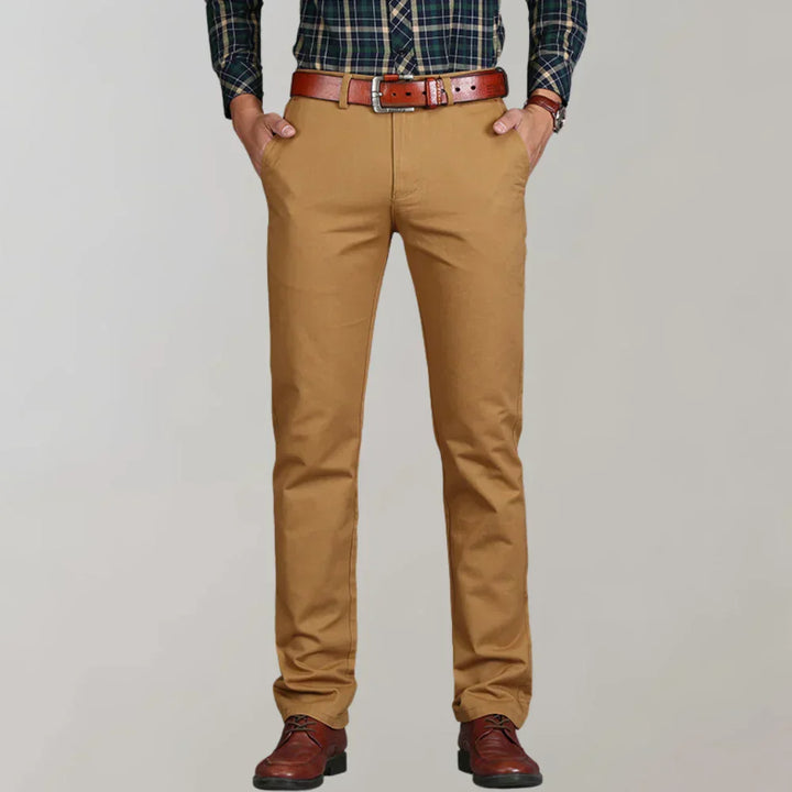 Close-up of men's slim fit chino pants, highlighting fabric texture and sleek modern cut. Perfect for stylish comfort.