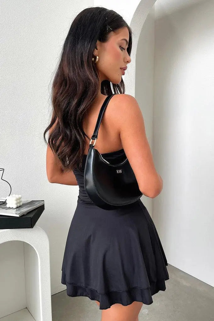Cute white strapless flowy mini dress with flared hem, a summer vacation essential.