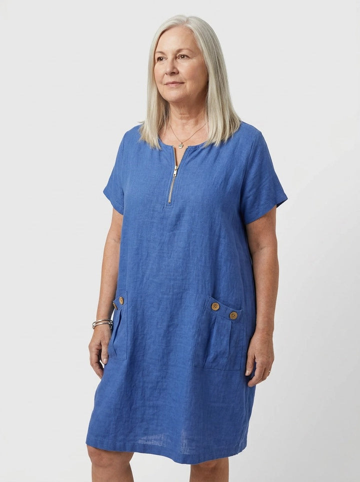 Blue women's casual summer dress, knee-length, with zip-front V-neck and practical pockets.