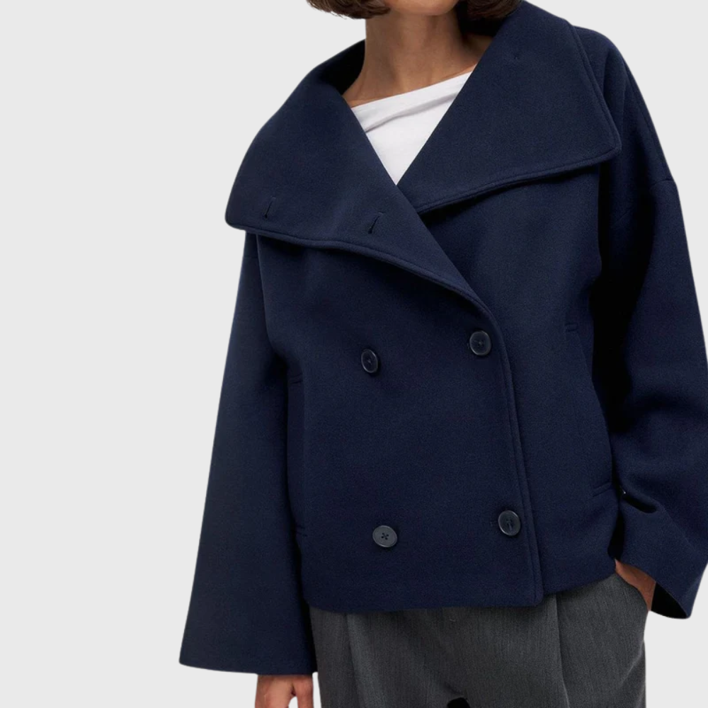 Modern women's cropped double-breasted jacket with stylish lapels for fall fashion.