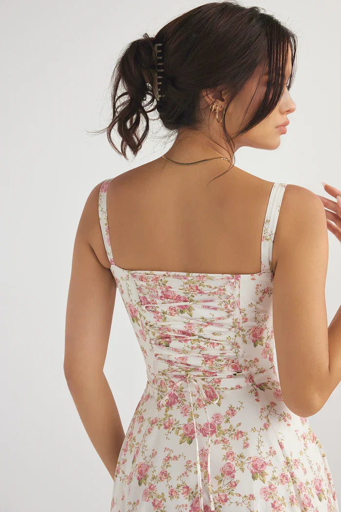 Full length shot of an elegant women's white floral corset midi dress. Perfect for evenings.