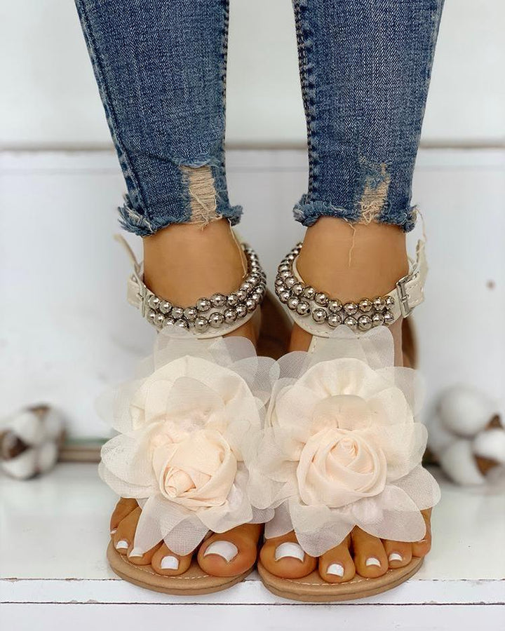 Comfortable women's flat sandals featuring elegant flower & pearl beaded ankle straps, perfect for summer.