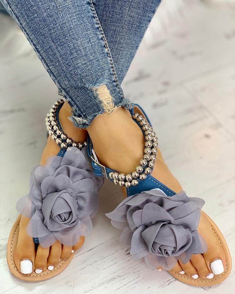 Fashionable & comfortable women's flat sandals with elegant flower & pearl beaded straps for summer wear.