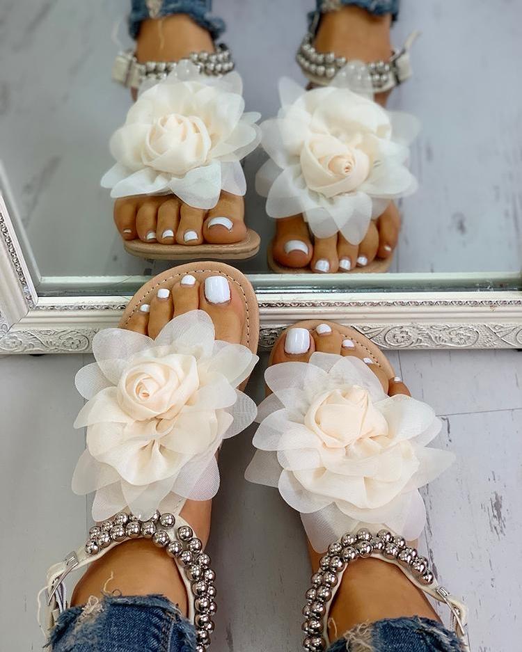 Stylish flat women's sandals with intricate flower & pearl beaded straps, ideal for elegant summer fashion.