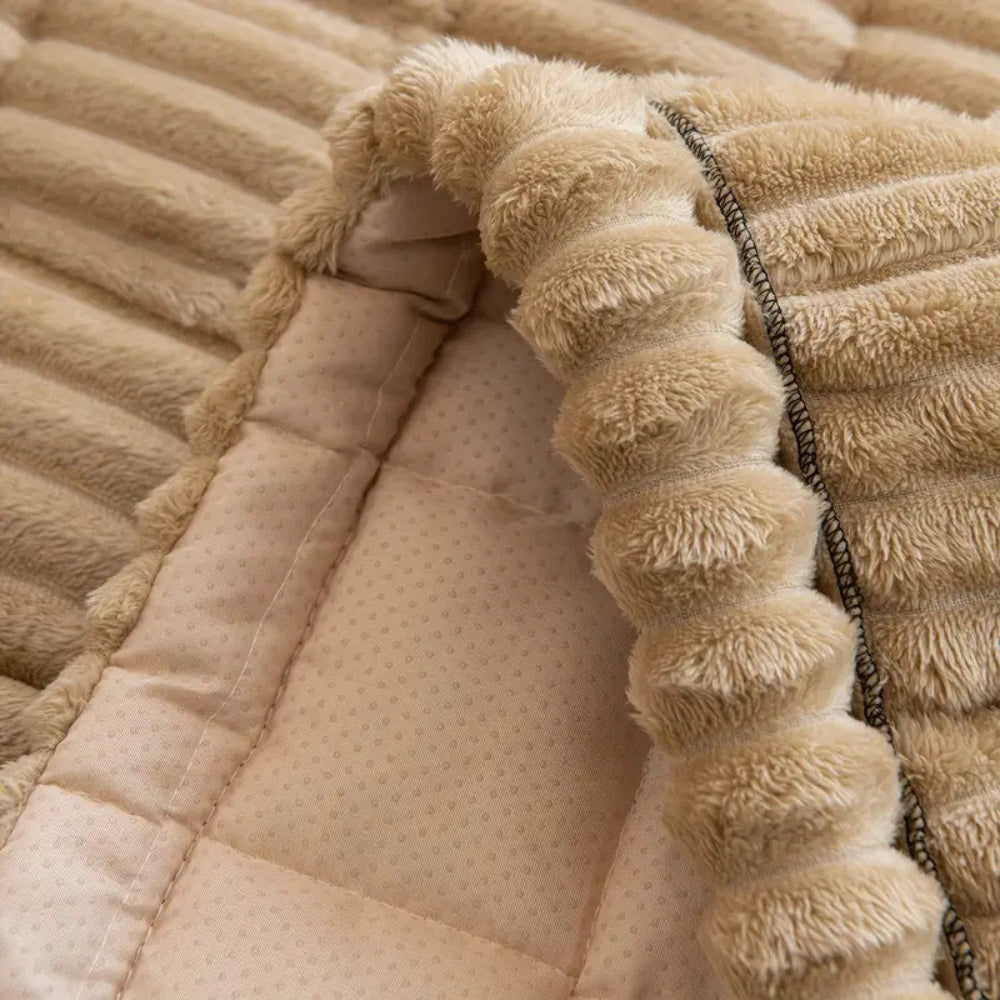 Stylish plush fleece sofa cover, quilted texture. Non-slip furniture protector enhances living room decor & comfort.
