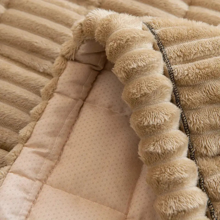 Stylish plush fleece sofa cover, quilted texture. Non-slip furniture protector enhances living room decor & comfort.