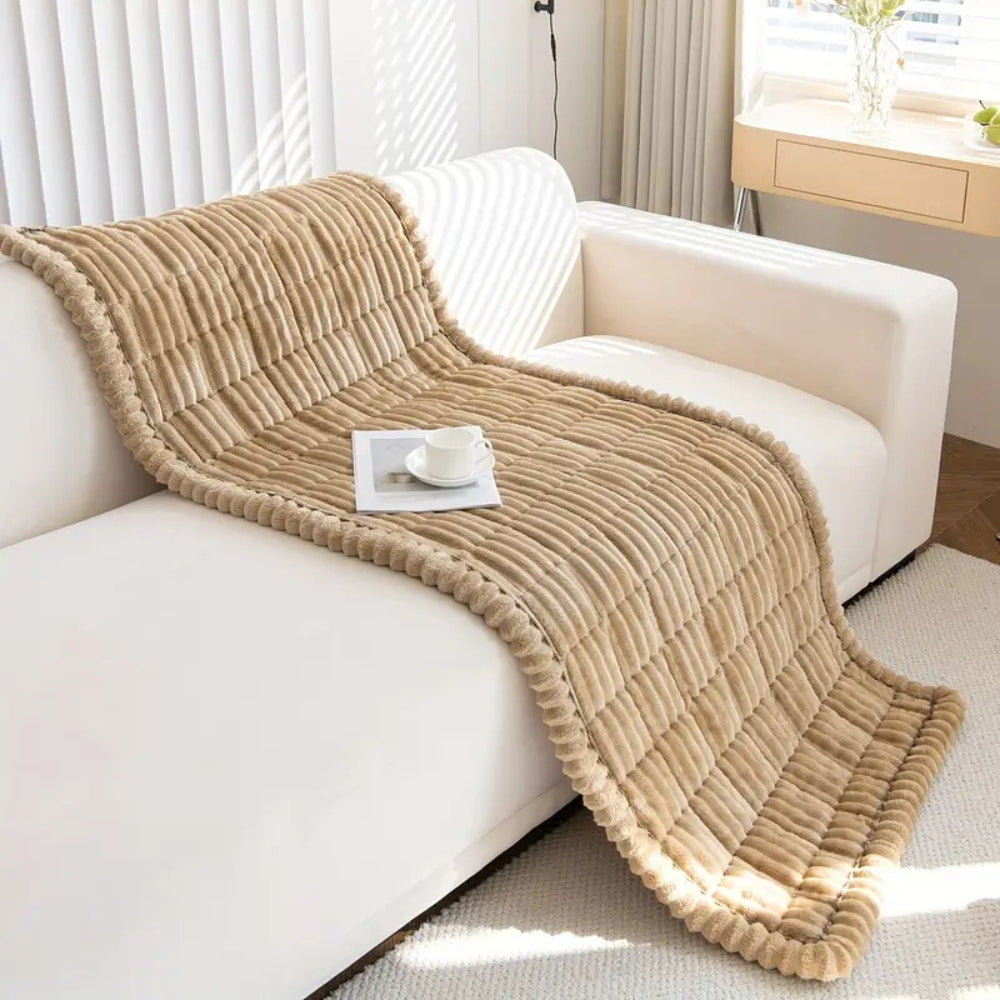 Close-up of plush fleece sofa protector mat, showcasing its soft quilted texture and non-slip backing for comfort.