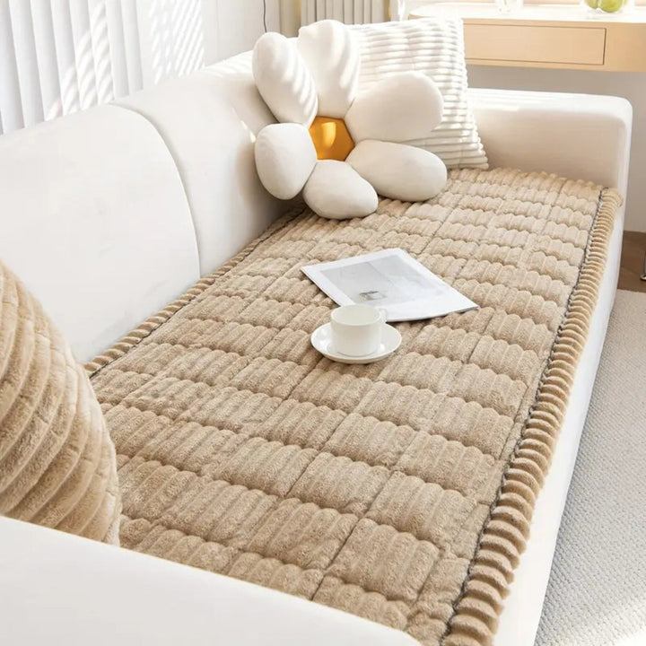 Pet-friendly plush fleece sofa protector. Non-slip quilted mat keeps furniture safe from pet hair and scratches.