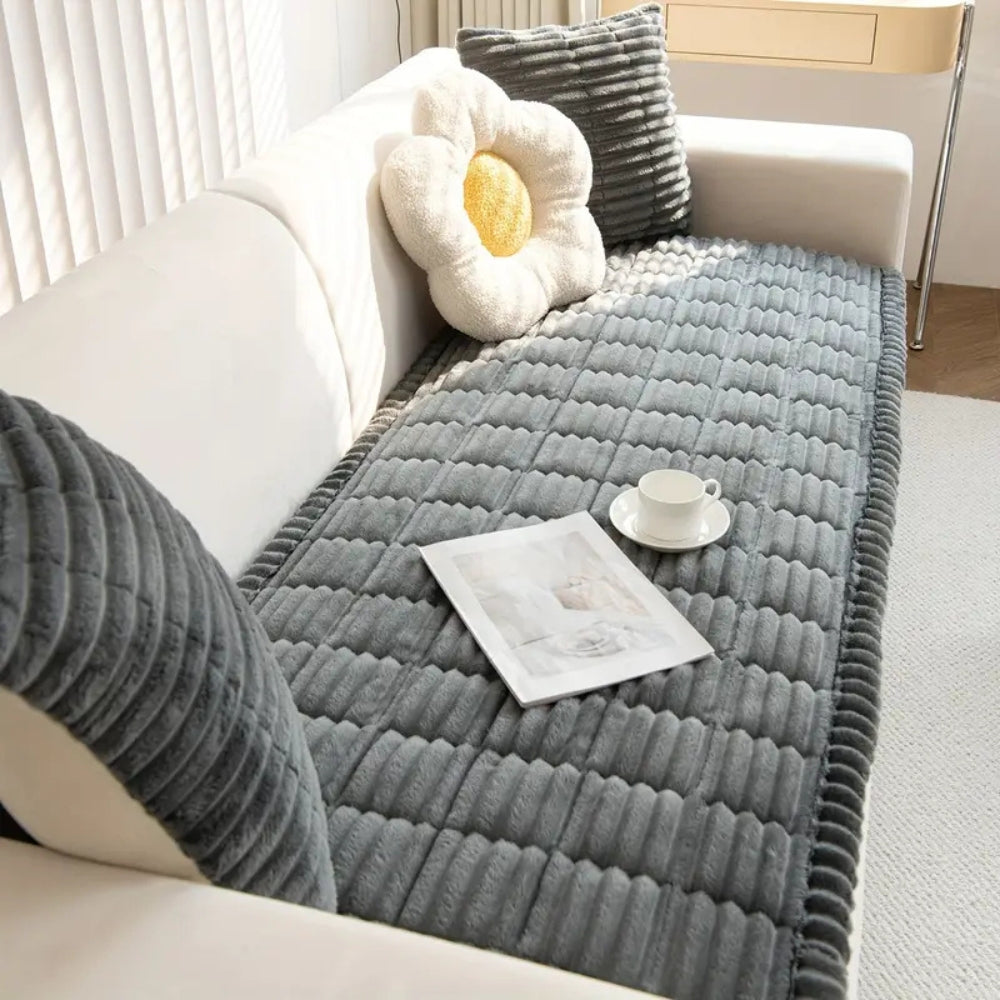 Durable non-slip sofa protector mat. Plush fleece quilted cover for furniture against spills, pets, and wear.