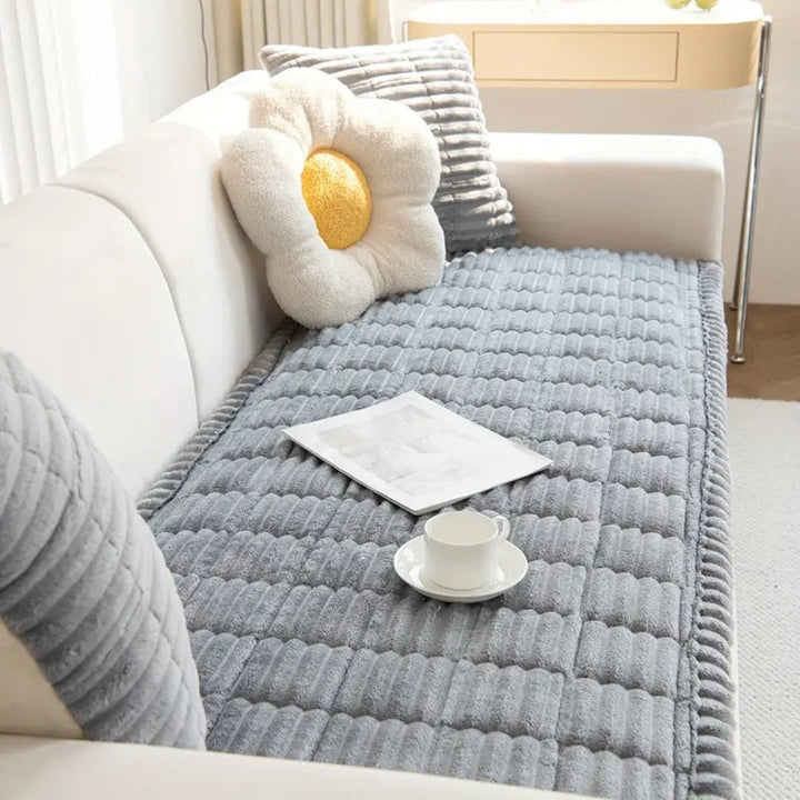 Non-slip sofa protector mat featuring soft plush fleece & quilted pattern. Secure furniture cover for lasting comfort.