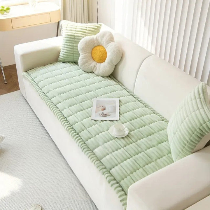 Luxurious plush fleece sofa mat with elegant quilting. Non-slip furniture protector adds comfort and style to any room.