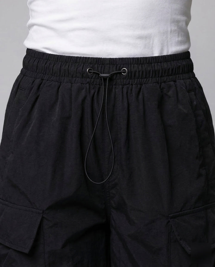 Stylish women's oversized cargo pants with multiple utility pockets and an adjustable waist for comfort.