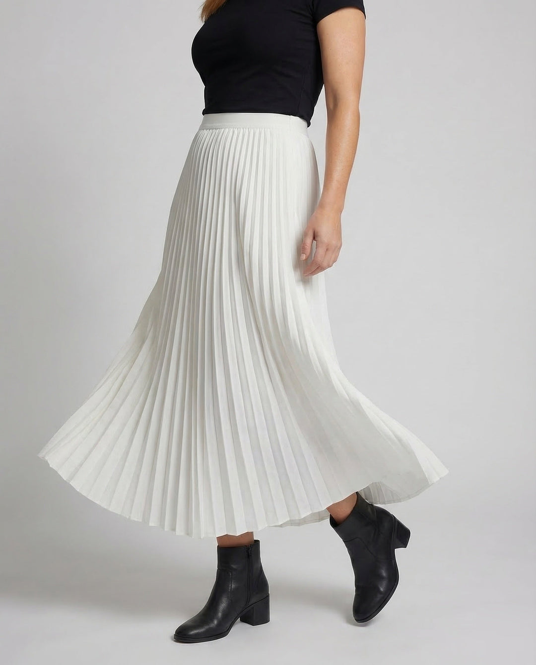 Flowy women's pleated midi skirt, ideal for elegant spring/summer fashion & comfortable modest wear.