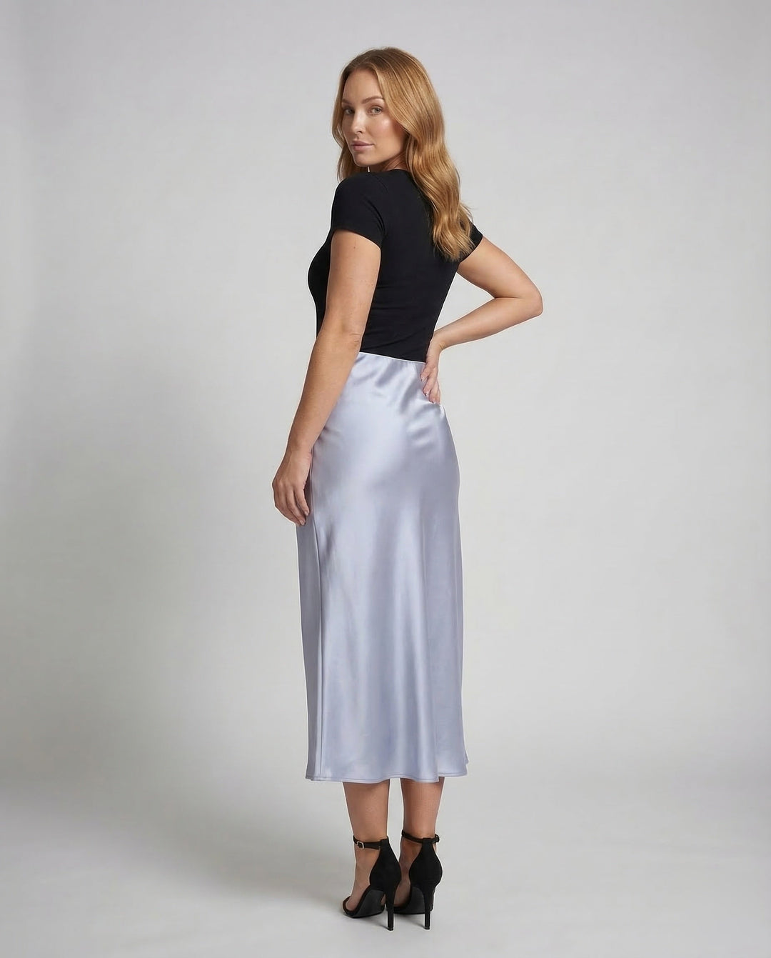 Chic white flowy midi skirt, a versatile high-waist bottom for women's elegant spring and summer apparel.
