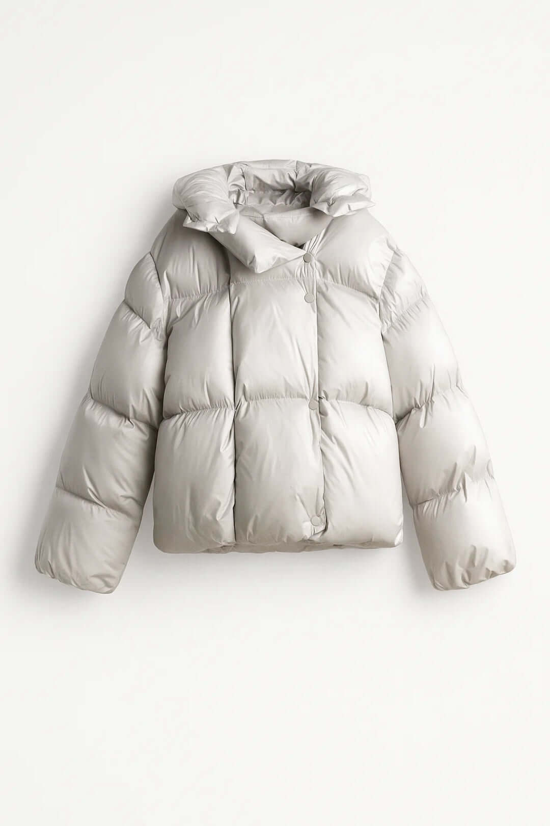 Women's voluminous puffer jacket, warm & modern winter style outerwear with snap closure for cold weather.