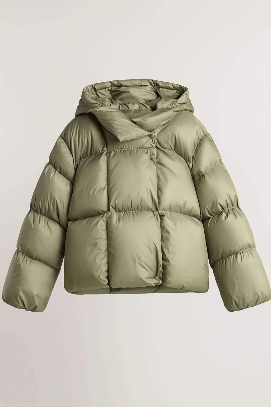 Fashionable women's winter jacket, voluminous design for warmth, ideal cold weather outerwear with snap closure.