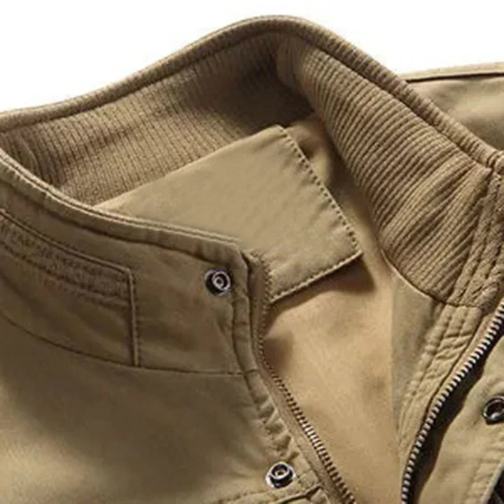 Durable green cotton multi-pocket vest for men. Sleeveless outdoor utility vest for fishing and hiking adventures.