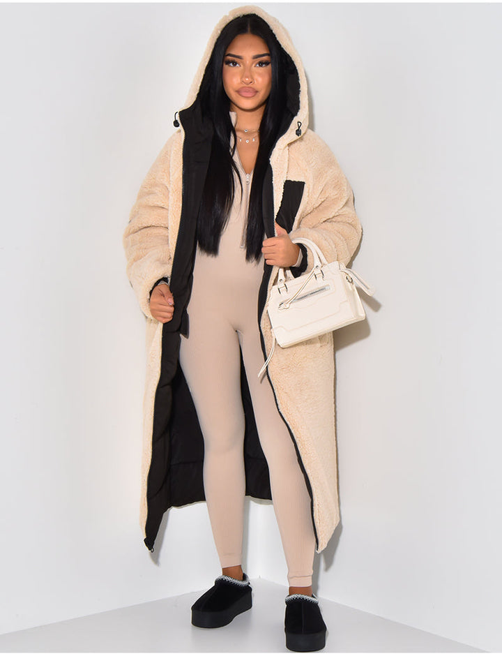 Practical women's reversible longline winter jacket. Offers cozy warmth, hooded protection & versatile cold weather style.