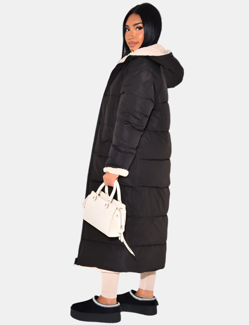 Stylish women's longline reversible winter jacket with quilted design. Warm, cozy, and perfect for cold weather.