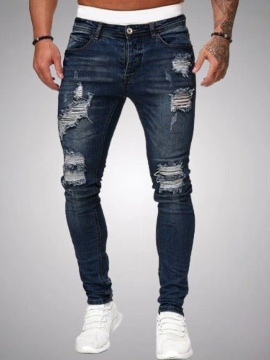 Modern men's slim fit distressed jeans, featuring trendy rips & a stylish, comfortable design.