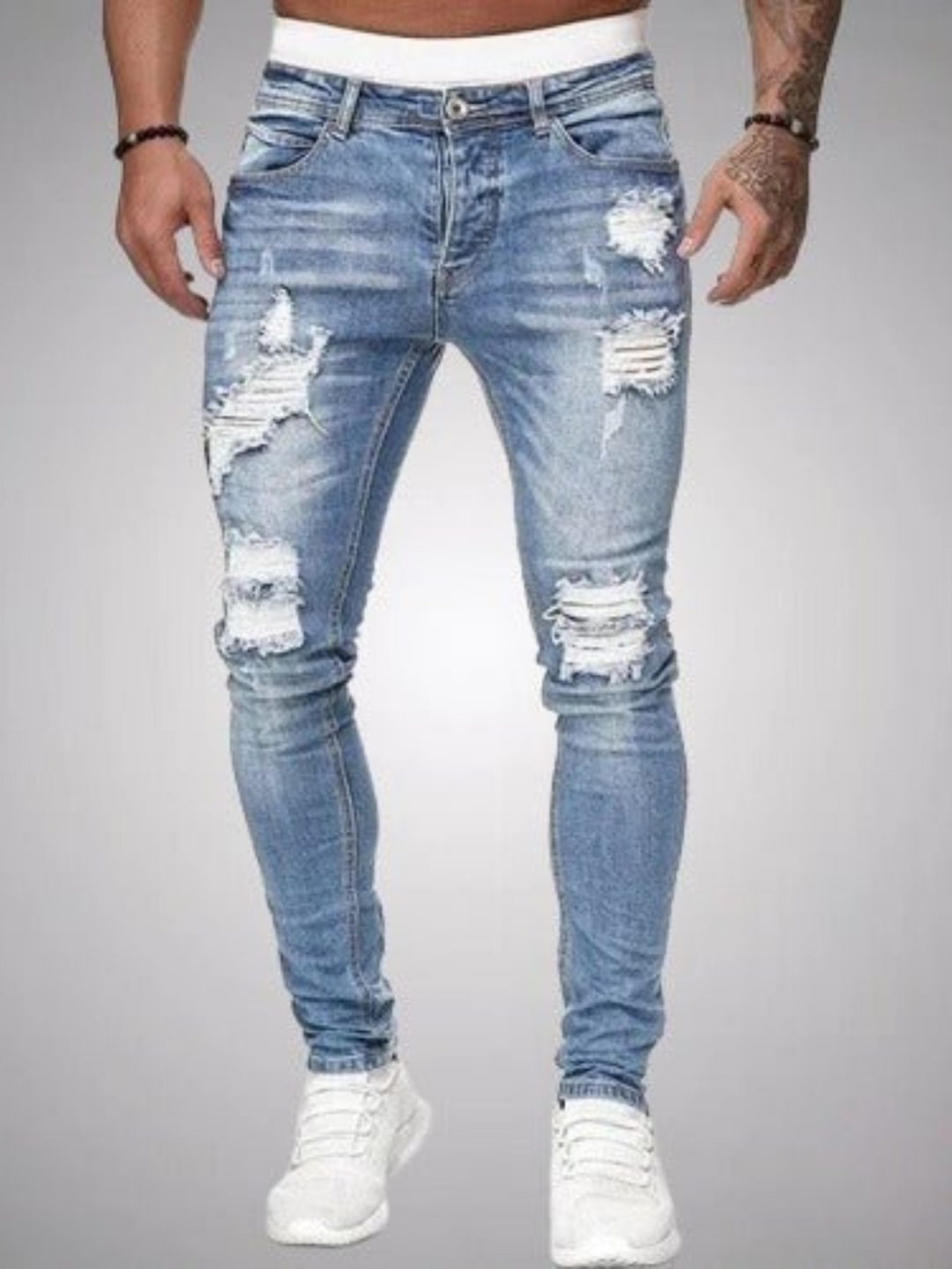 Stylish men's ripped slim fit jeans, blue denim, modern distressed design for a trendy casual outfit.