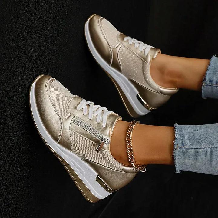Fashionable metallic platform trainers for women, featuring a practical side zip and supportive orthopaedic design.