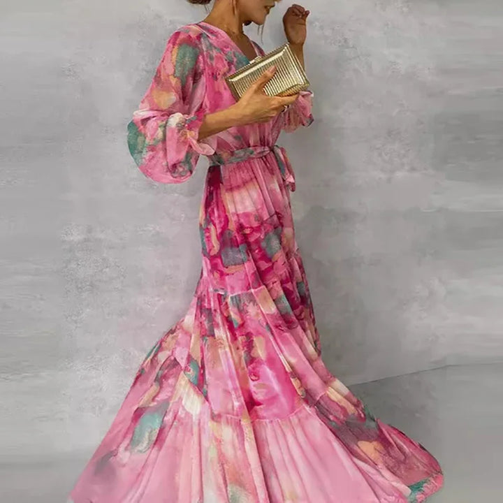 Women's elegant pink floral print midi wrap dress with flattering silhouette, perfect as a wedding guest or summer dress.