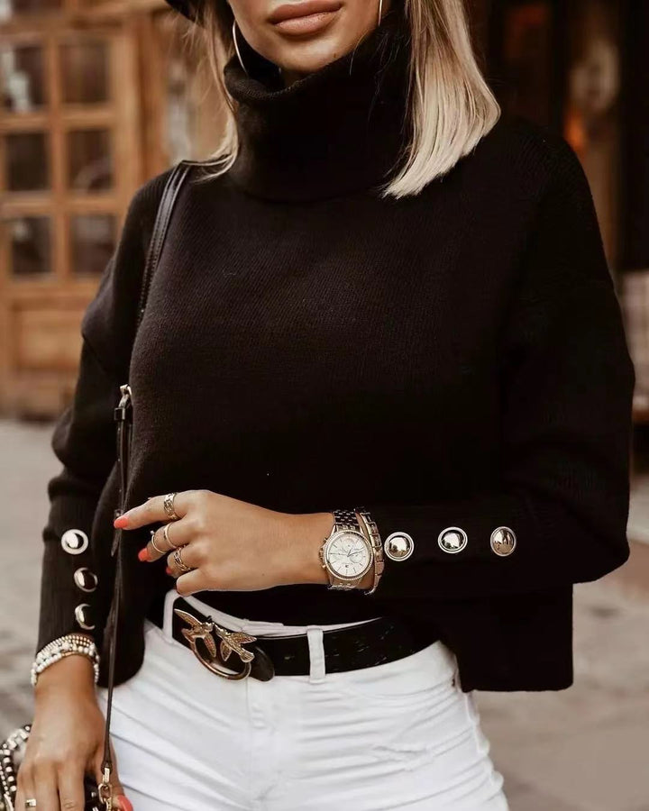 Cozy ribbed knit women's turtleneck sweater with fashionable button sleeves. Versatile winter style knit.