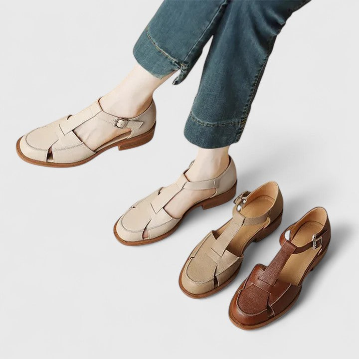 Beige closed-toe T-strap sandals for women with an adjustable strap, combining comfort and elegant style.