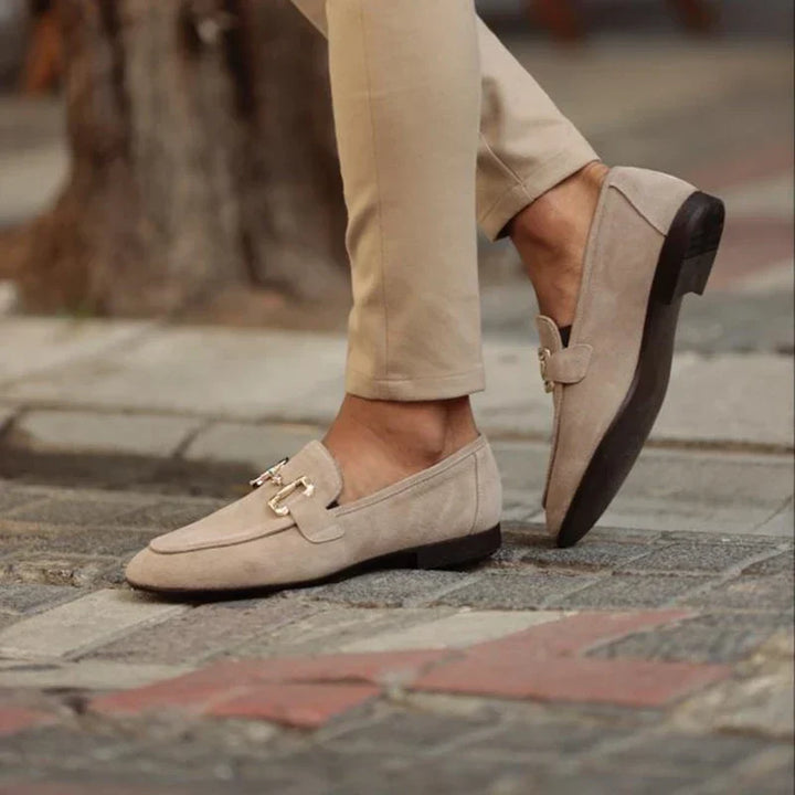 Classic men's leather-look slip-on loafers. Elegant dress shoes with a sleek metal buckle, perfect for formal wear.