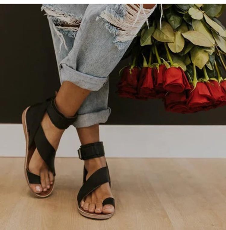 Elegant women's orthopedic sandals with cross strap & toe ring, providing stylish comfort & foot support.