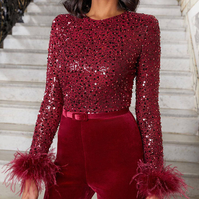 Luxurious women's sequin feather jumpsuit, perfect for a special occasion, featuring sparkle and a flared leg.