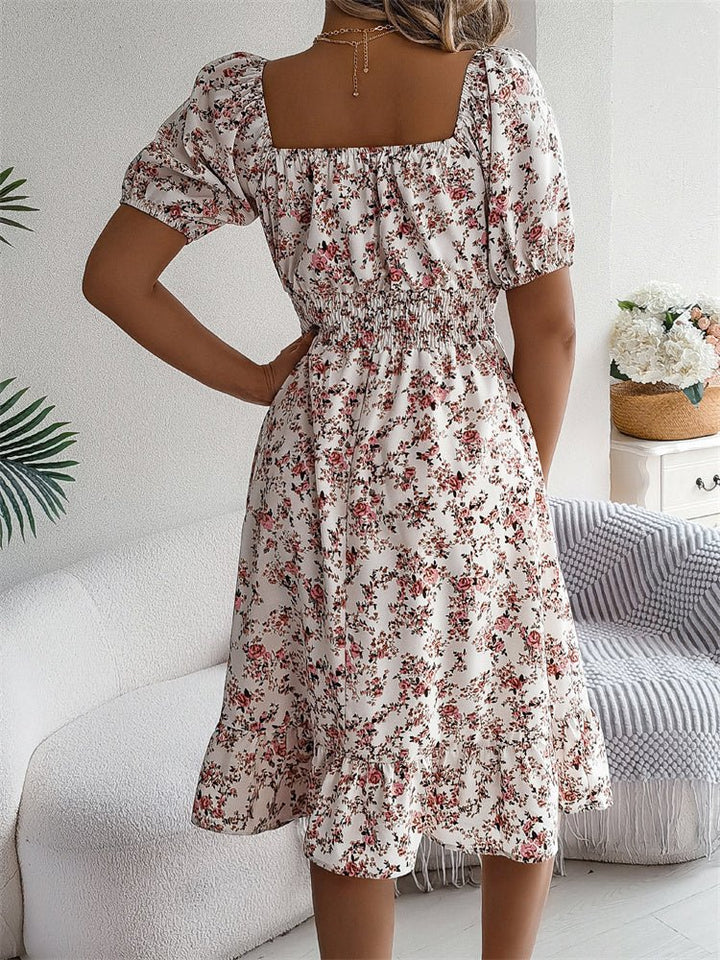 Elegant women's floral midi dress, smocked waist, puff sleeves. Summer garden party outfit idea.