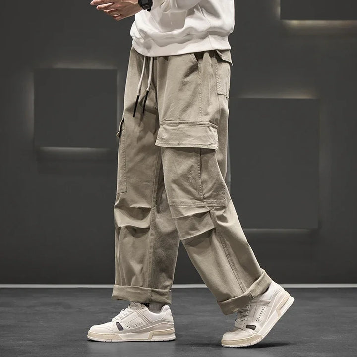 Comfortable men's relaxed fit wide leg cargo trousers with a practical drawstring waist and flap pockets.