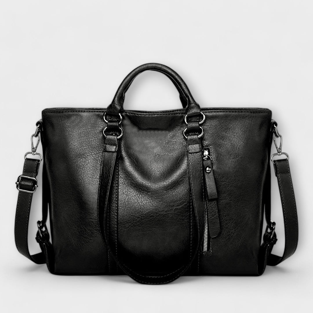 Spacious black leather tote bag for women, ideal for work or daily essentials, versatile.