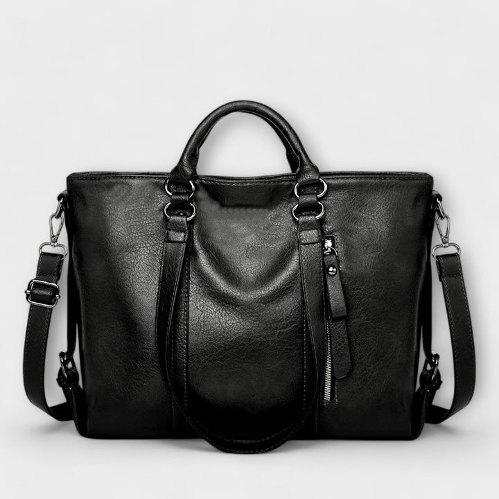 Spacious black leather tote bag for women, ideal for work or daily essentials, versatile.