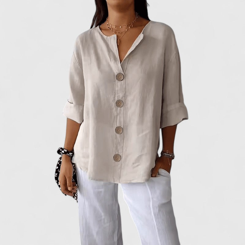 Women's elegant V-neck button-front blouse in a light fabric, perfect for versatile spring/summer fashion.