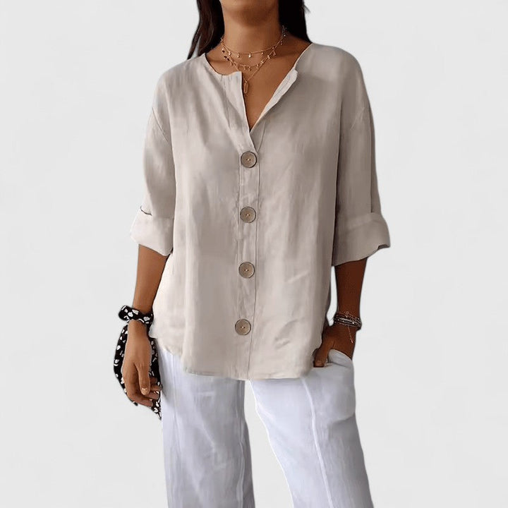 Women's elegant V-neck button-front blouse in a light fabric, perfect for versatile spring/summer fashion.