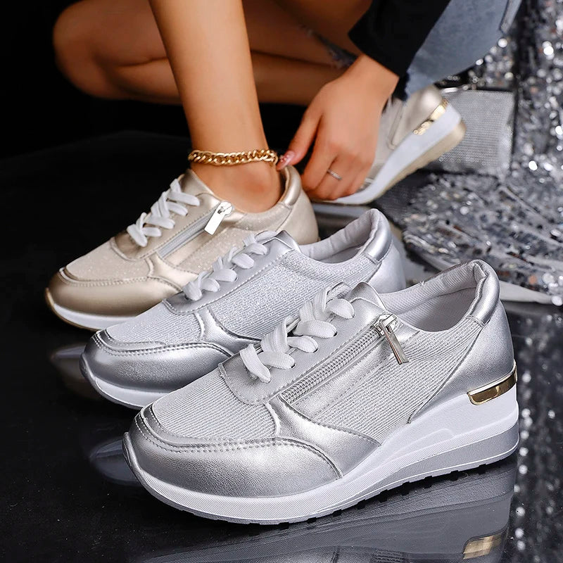 Trendy women's orthopaedic platform trainers with metallic accents and a practical side zip for comfort.