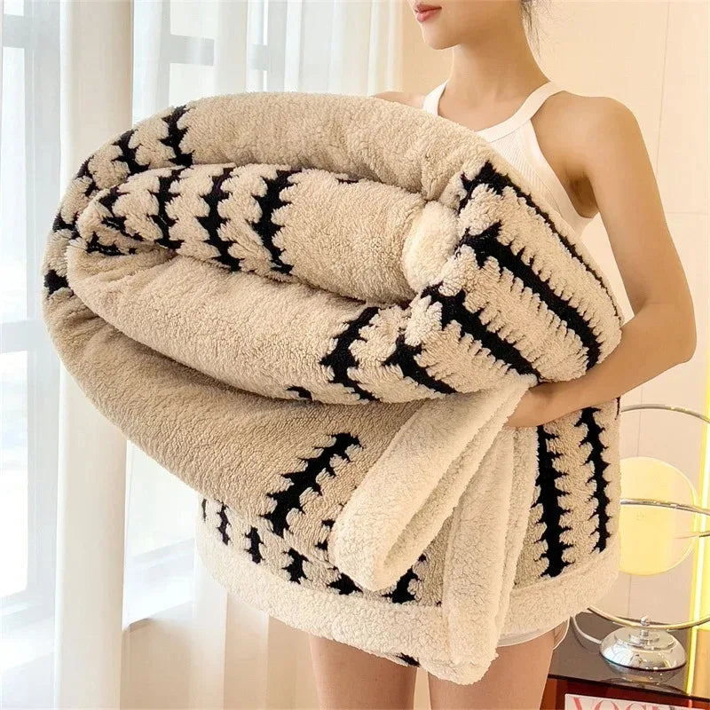Reversible geometric throw blanket with soft sherpa fleece for cozy living room decor.